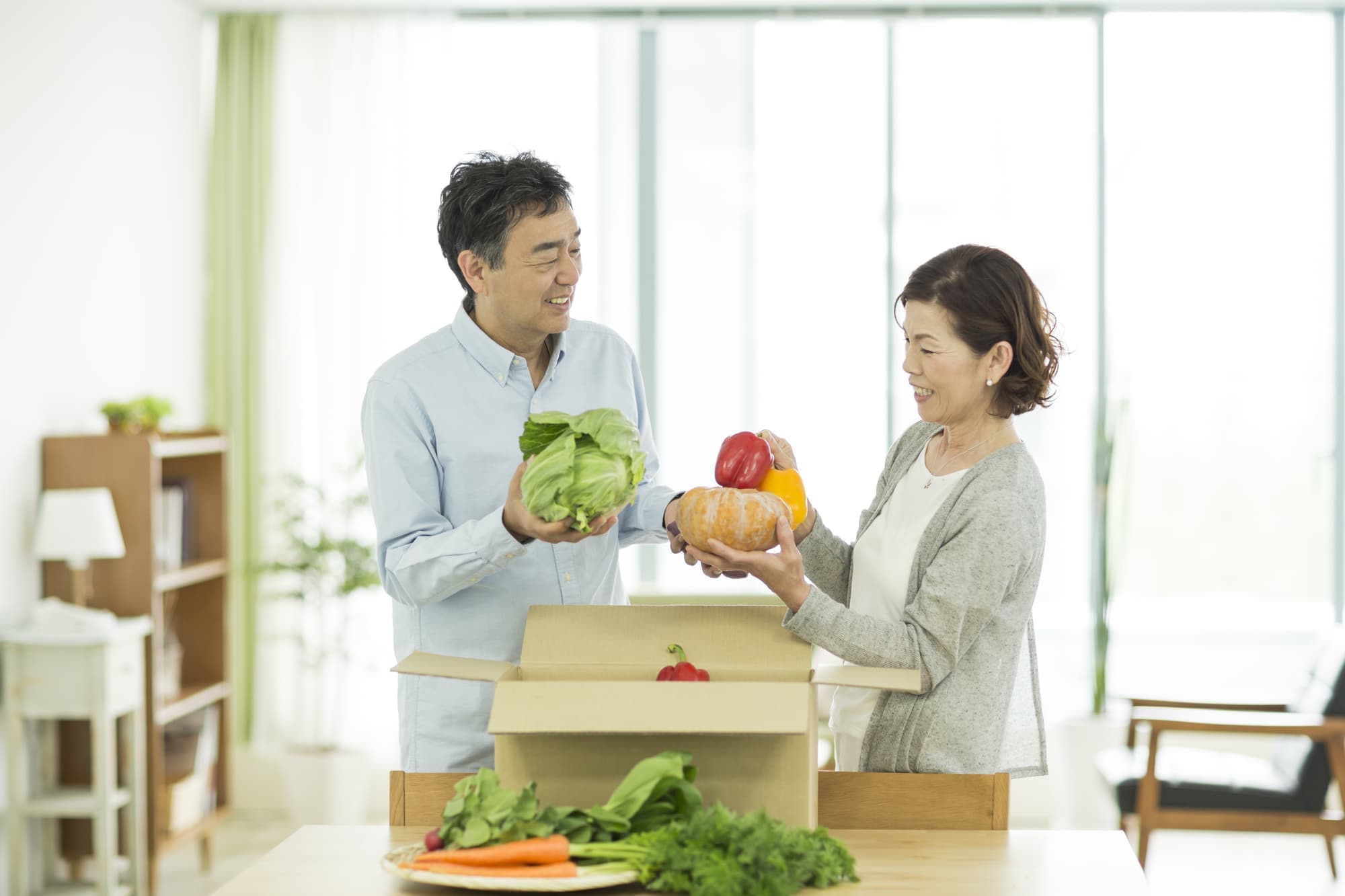 A happy old couple preparing to deliver a present